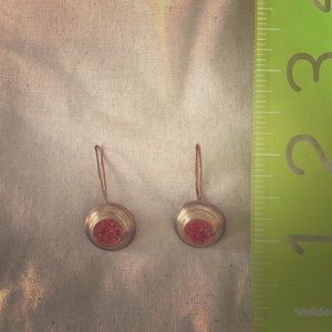 Gold drop earring with orange crushed stone.